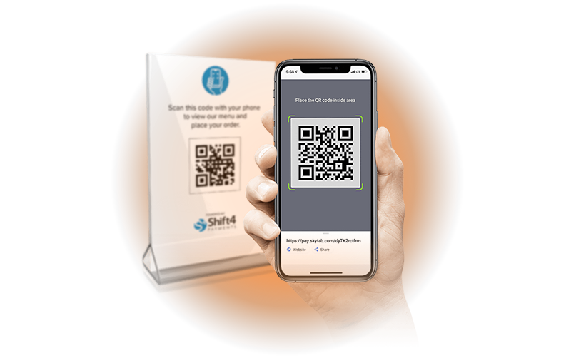 A person's hand is holding a smartphone displaying a QR code, with another QR code on a stand in the background. The text "Scan this code with your phone to view our menu and place your order" is visible on the stand, along with the Shift4 logo. The smartphone's screen also displays instructions for placing the QR code inside a designated area. The background is a soft gradient of orange and gray.